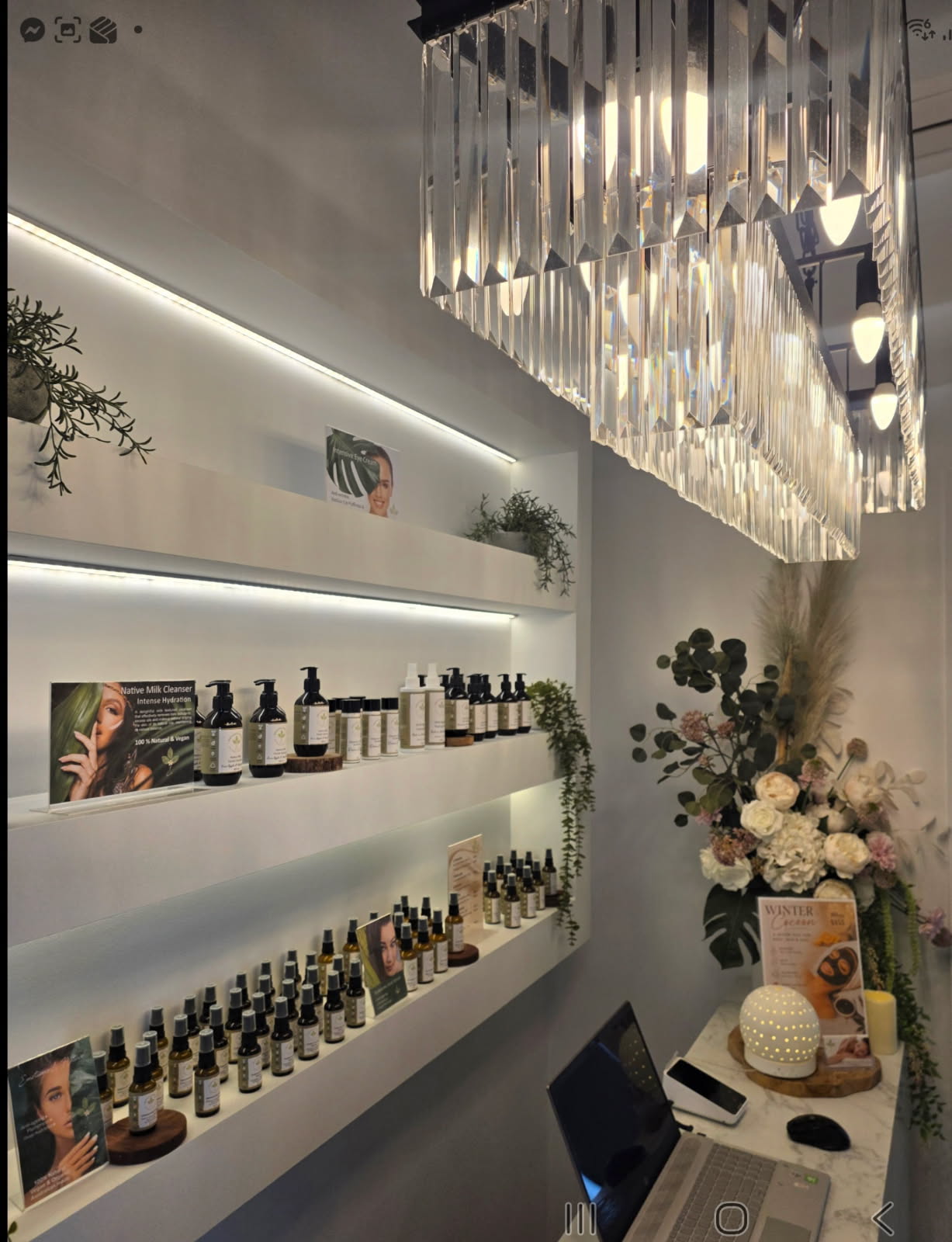 Natural, Australian made skincare on the shelves at the studio, under the crystal chandelier